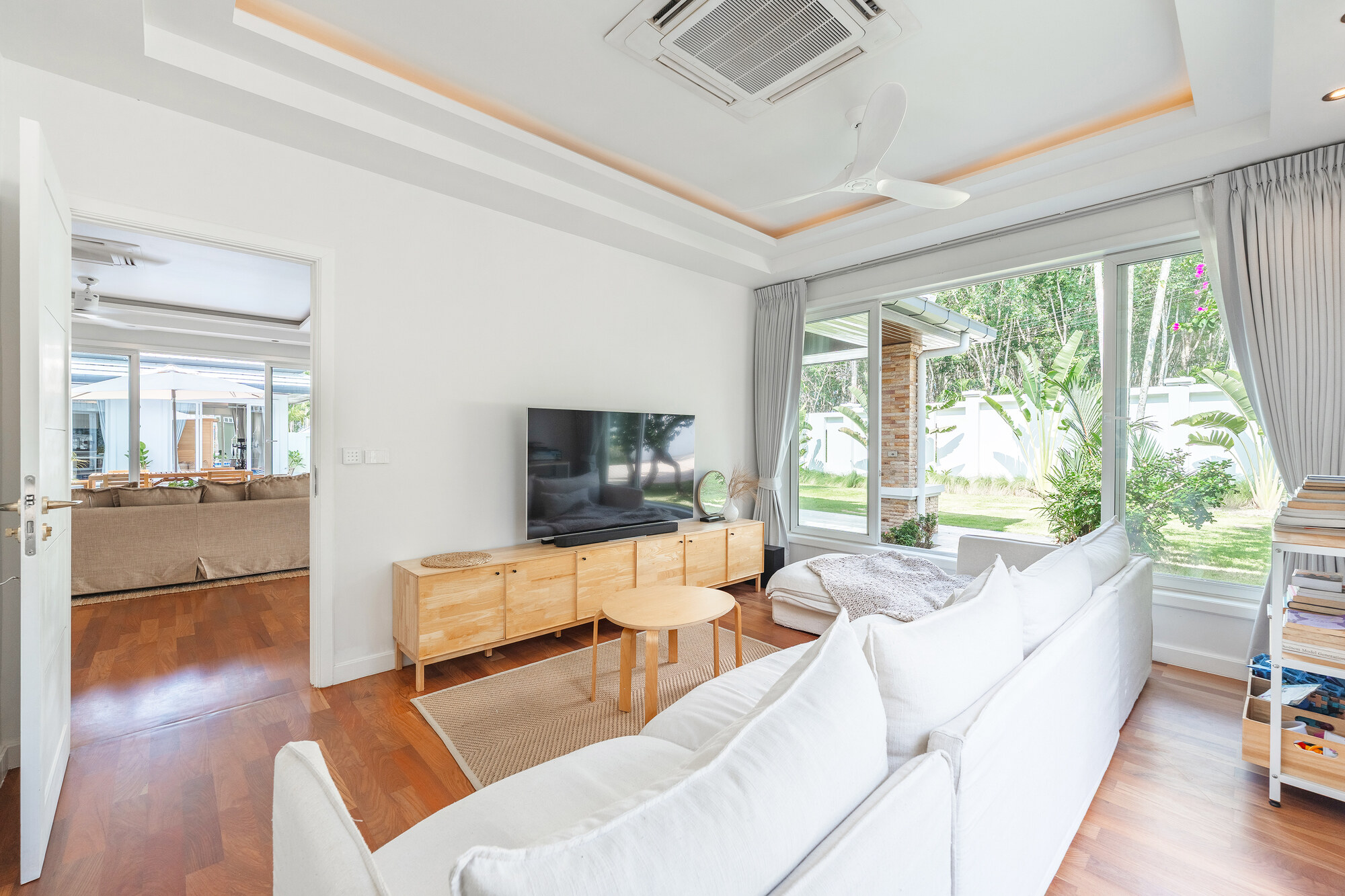 Bright Villa Bussaba TV room opening onto the garden